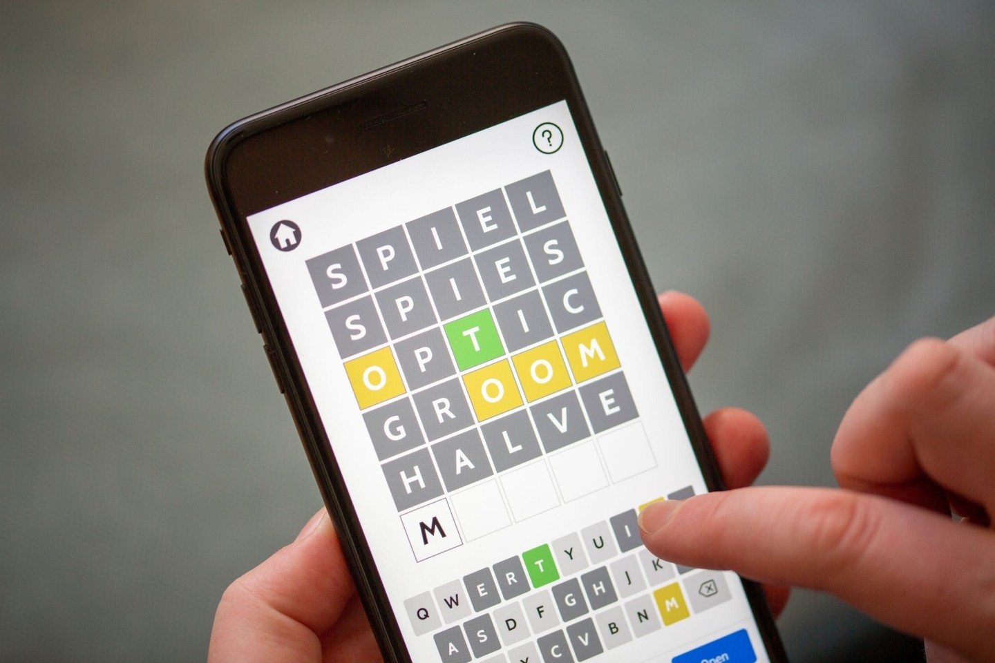 Eine Person spielt mit der App eines Online-Buchstabenrätsels.