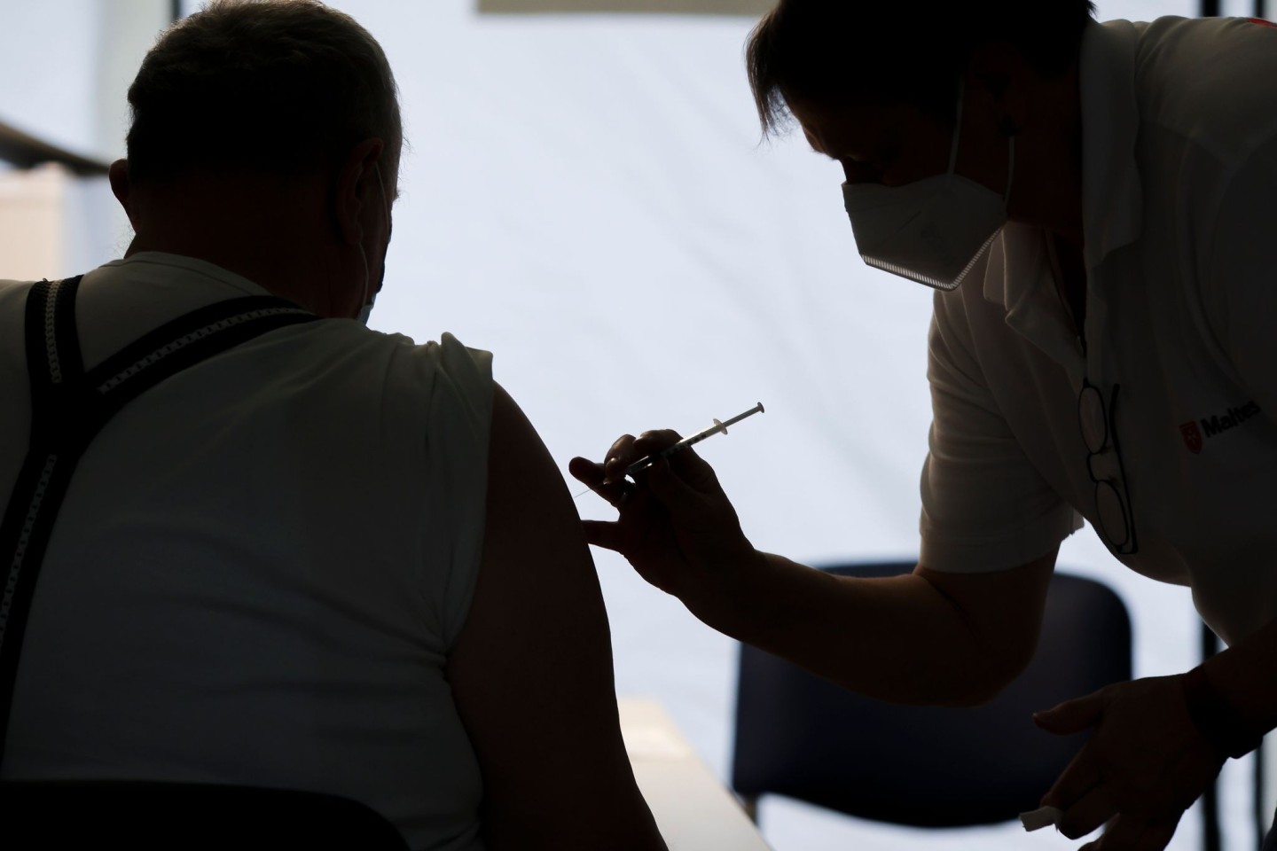 Eine Mitarbeiterin der Malteser impft einen Bürger in einem Impfzentrum in Sachsen-Anhalt. Experten halten die vom designierten Bundeskanzler Olaf Scholz (SPD) angepeilten 30 Millionen zus...