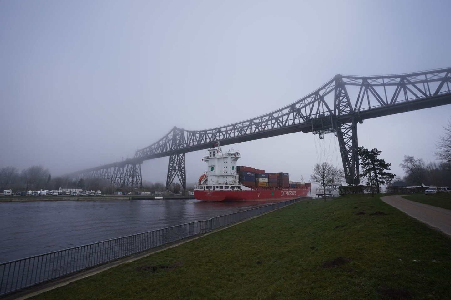 Ein Containerschiff im Frühnebel auf dem Nord-Ostsee-Kanal unter der Rendsburger Hochbrücke Anfang März 2022.