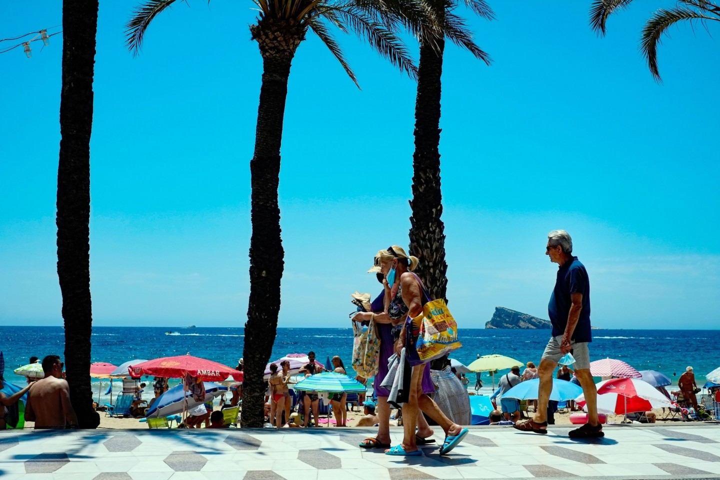 Menschen genießen einen Sommertag am Strand im spanischen Benidorm. Wegen stark steigender Corona-Infektionszahlen stuft die Bundesregierung am Sonntag ganz Spanien als Risikogebiet ein.